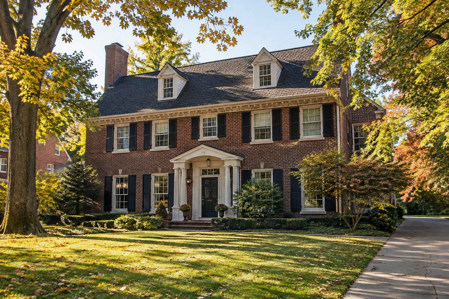 A brick colonial home on a tree lined Michigan street